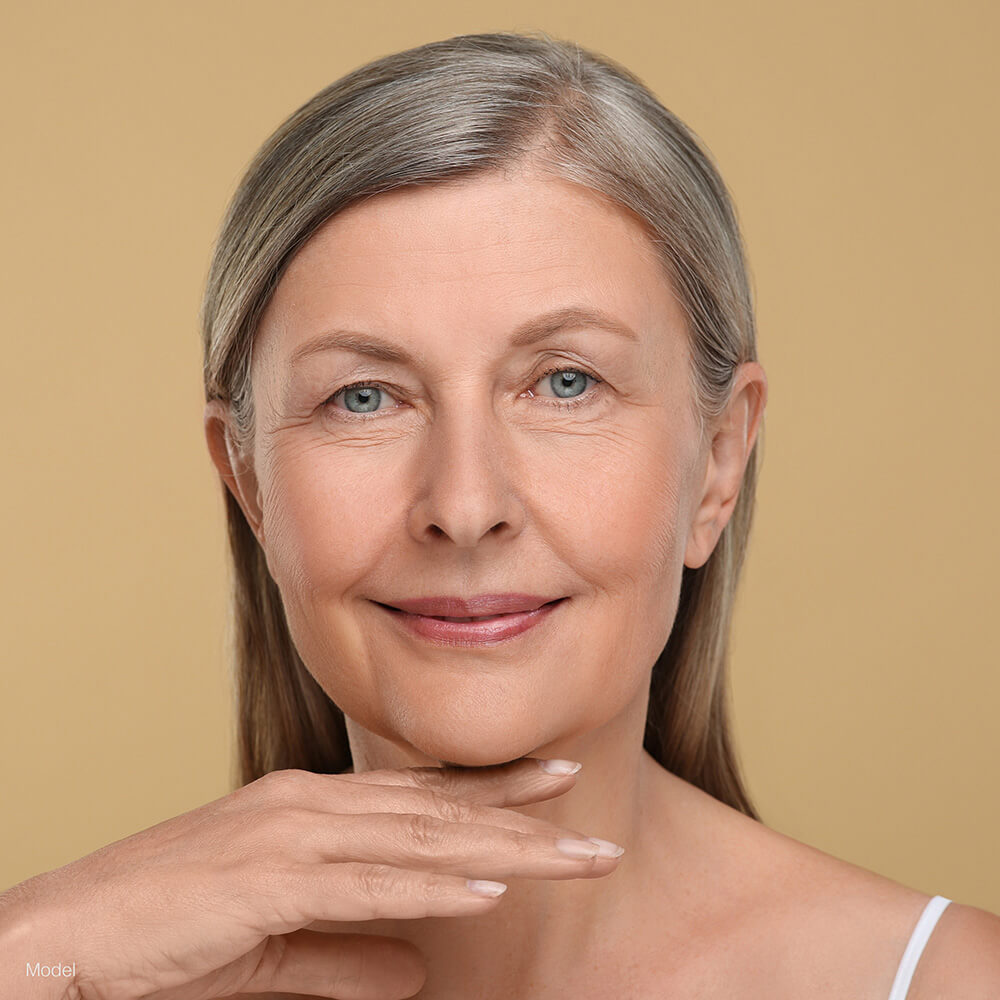 Mature woman touching her chin